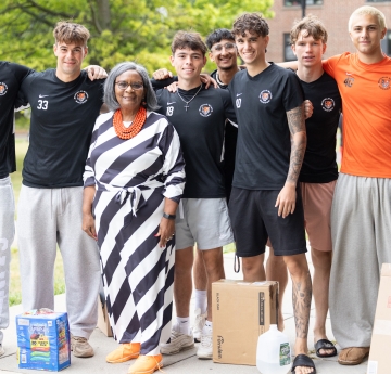 Bonita R. Durand, Ph.D., standing with soccer team