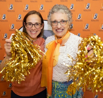 Two women with pom moms
