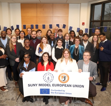 Group of students holding event sign