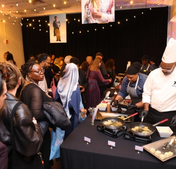Chef cooking food and event attendees