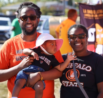 Two alumni with baby