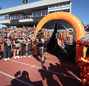 Football players running onto field