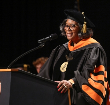 Bonita R. Durand, Ph.D., at podium in academic regalia