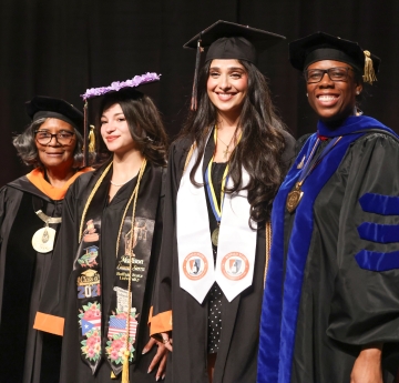 Two graduates with president and provost