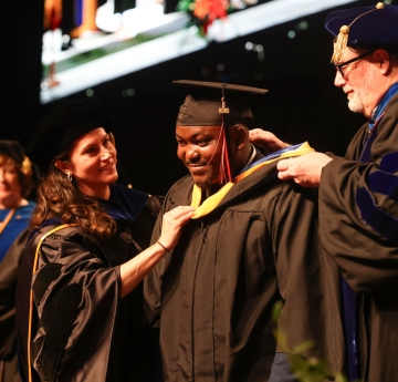 Graduate receiving master's hood