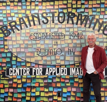 Man in front of wall with colorful graphics