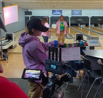 Students with camera on set at bowling alley