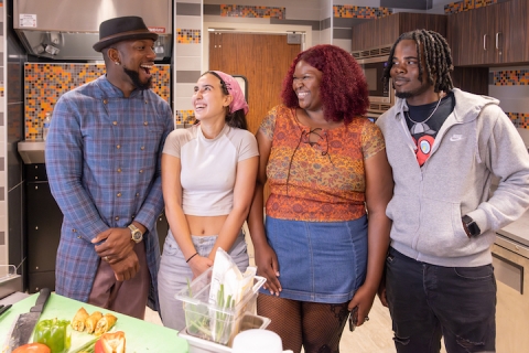 Darian Bryan with students in kitchen