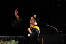 Person in cap and gown at graduation