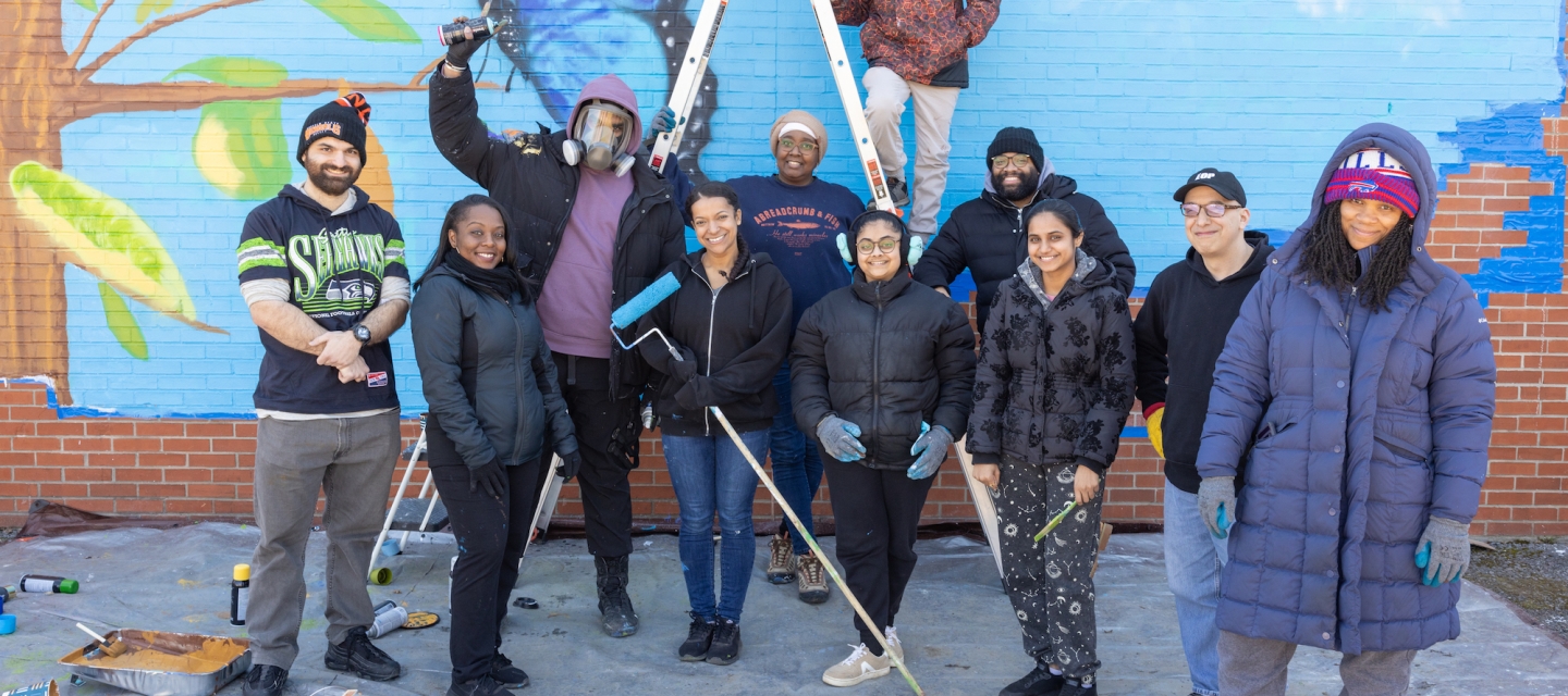 Group of students with paint brushes