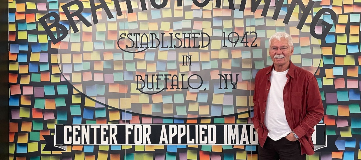 Man in front of wall with colorful graphics