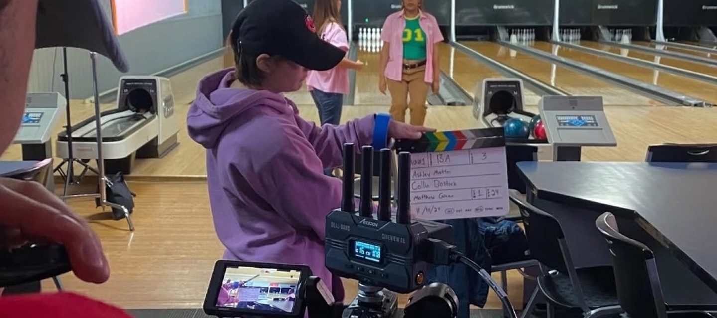 Students with camera on set at bowling alley