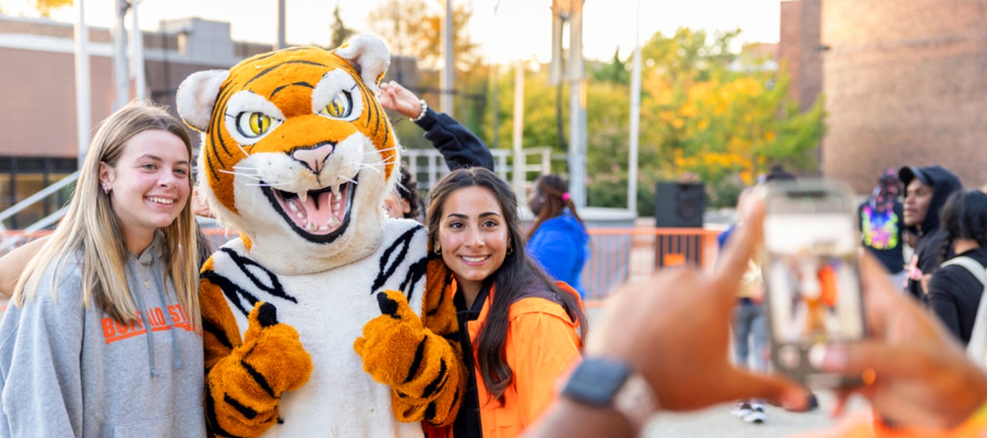 Students posing with the Bengal while having a photo taken.