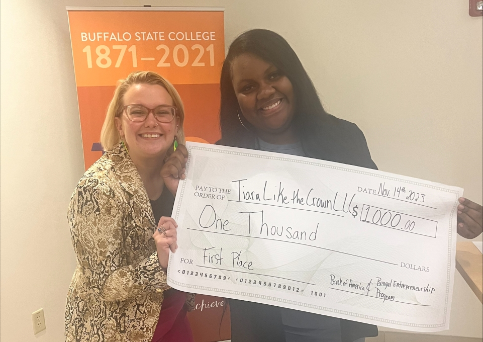 Tiara Gilman with her $1,000 check