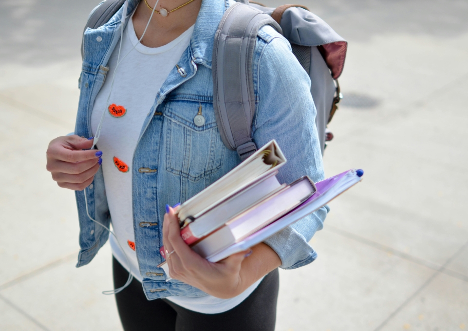 A female student carries books